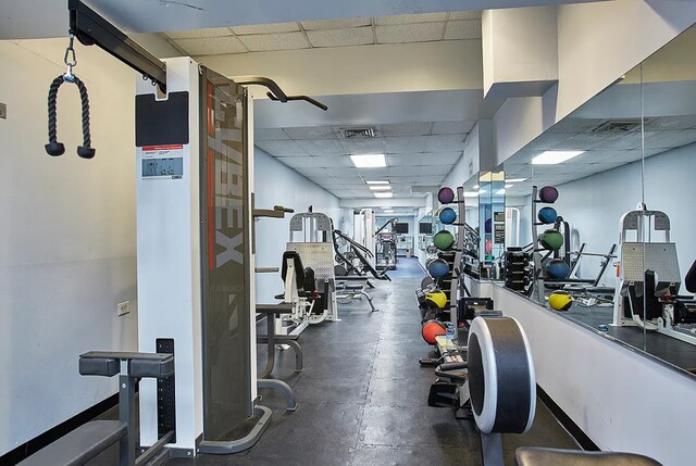 workout area with visible vents and a drop ceiling