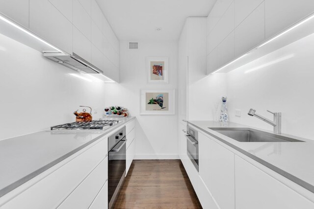 stairs featuring a wall unit AC, a high ceiling, a chandelier, and wood finished floors