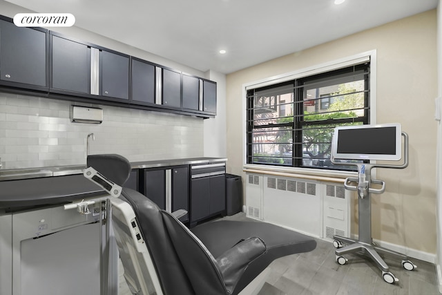 office with baseboards, recessed lighting, visible vents, and radiator