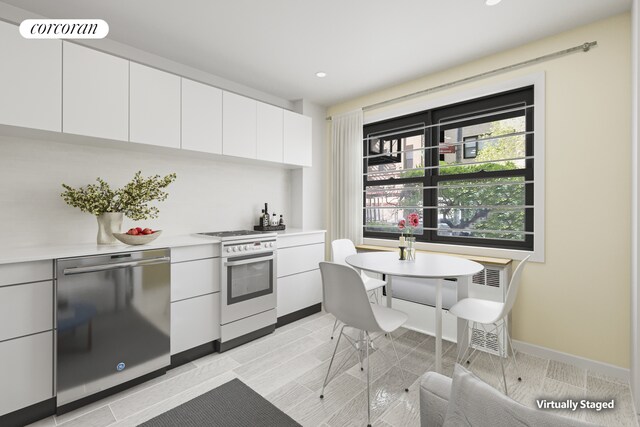 kitchen featuring stove, visible vents, white cabinets, light countertops, and dishwasher