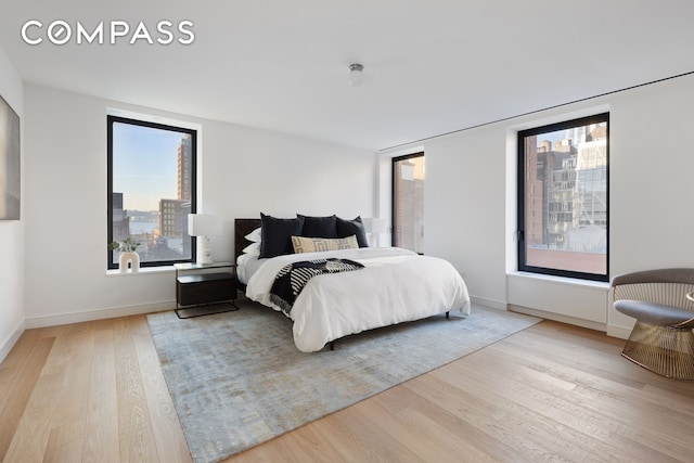 bedroom with baseboards and wood finished floors