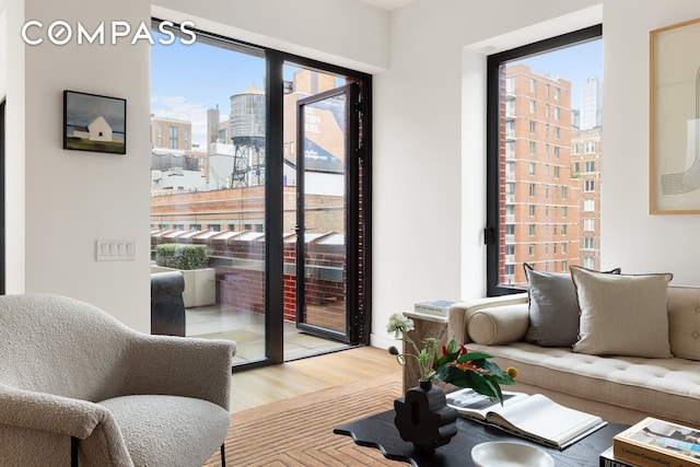 living area with a city view and wood finished floors