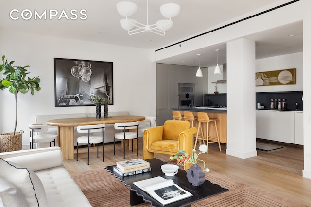 living area with an inviting chandelier and wood finished floors