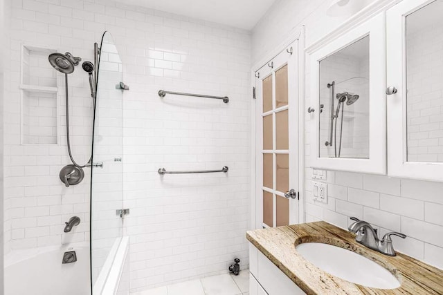 full bath featuring vanity, tile patterned flooring, tile walls, bathing tub / shower combination, and tasteful backsplash