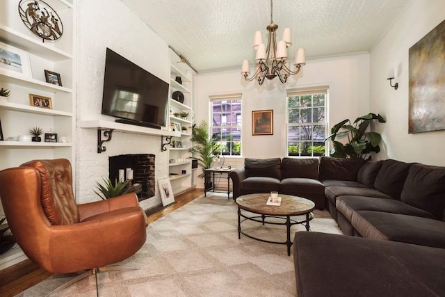 living room with built in features, an inviting chandelier, a fireplace, and a textured ceiling