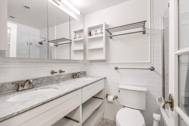 bathroom featuring a sink, an enclosed shower, and toilet