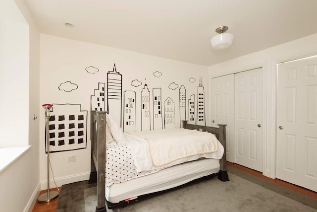 bedroom featuring baseboards and a closet