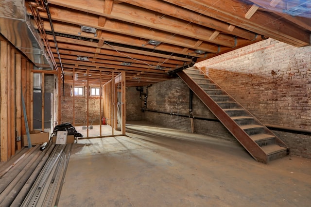 basement featuring brick wall