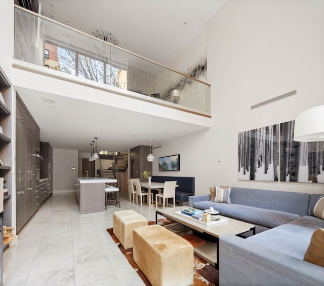 tiled living room with a high ceiling