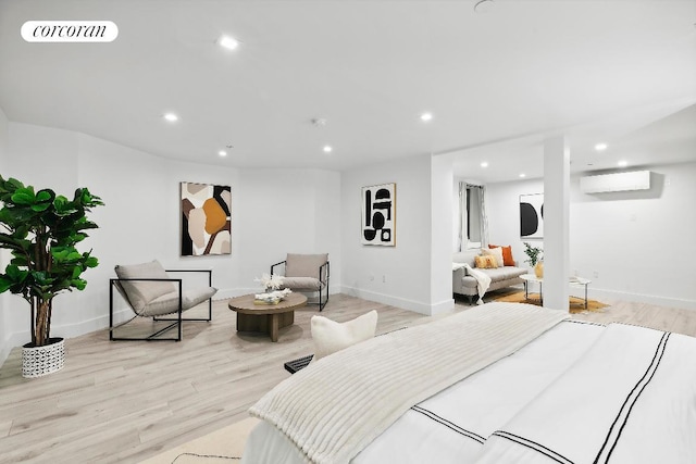 bedroom featuring an AC wall unit and light wood-type flooring