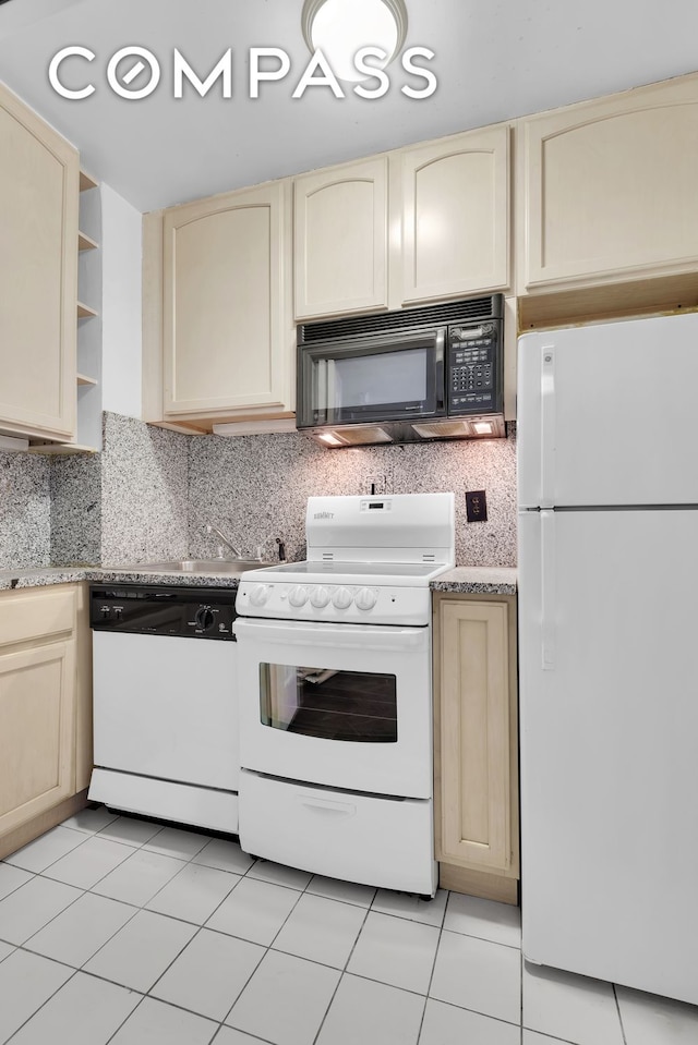 465 Park Ave Unit 26C, New York City, NY 10022 - kitchen with white appliances, cream cabinets, and tasteful backsplash