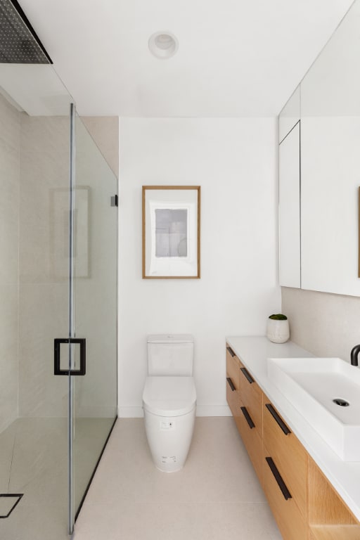 bathroom featuring a shower with door, toilet, tile patterned flooring, and vanity