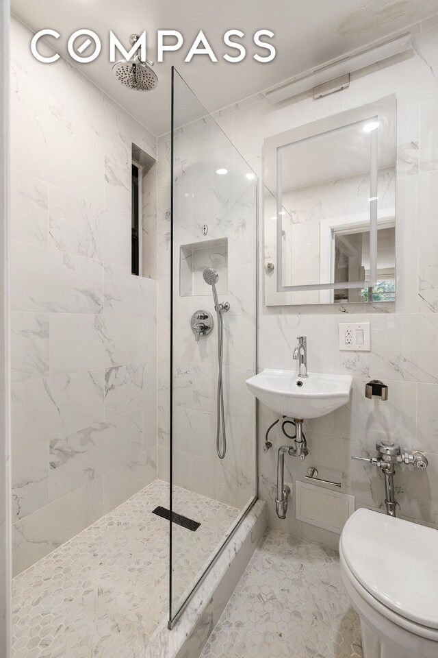330 E 90th St Unit 3D, New York City, NY 10128 - bathroom with a marble finish shower, marble finish floors, toilet, and a sink