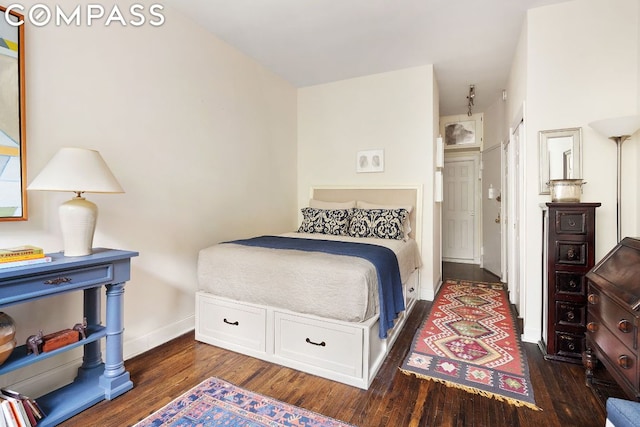 bedroom with dark hardwood / wood-style flooring