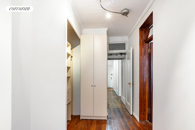 hall with visible vents, ornamental molding, and hardwood / wood-style floors