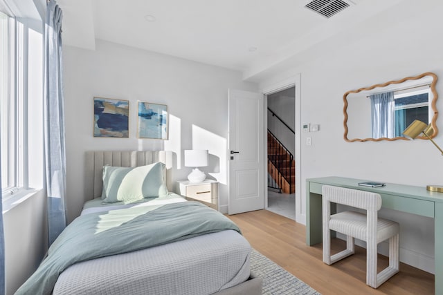 bedroom with visible vents and light wood-style flooring