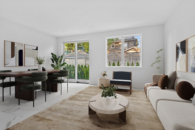 living area featuring marble finish floor