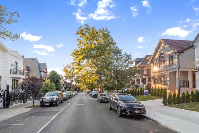 view of road with sidewalks, a residential view, and curbs