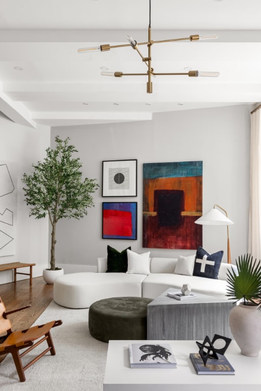 living room featuring a chandelier, hardwood / wood-style floors, and beam ceiling