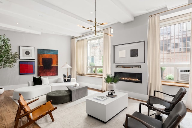 living room featuring an inviting chandelier, light hardwood / wood-style floors, and beamed ceiling