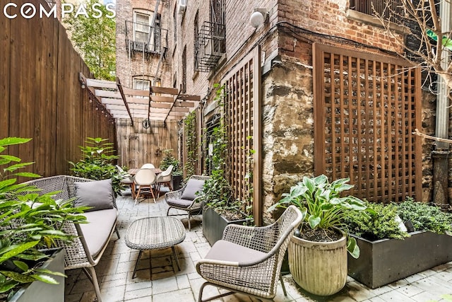 view of patio / terrace with an outdoor hangout area and a pergola