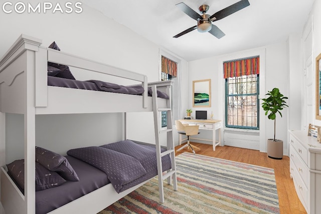 bedroom with ceiling fan and light wood-type flooring