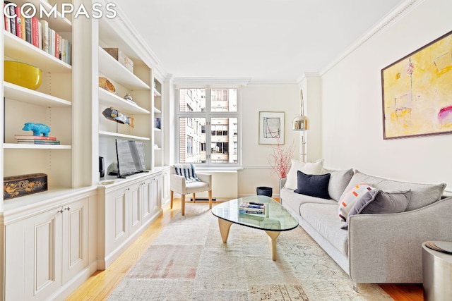 living room with ornamental molding, built in features, and light wood-type flooring