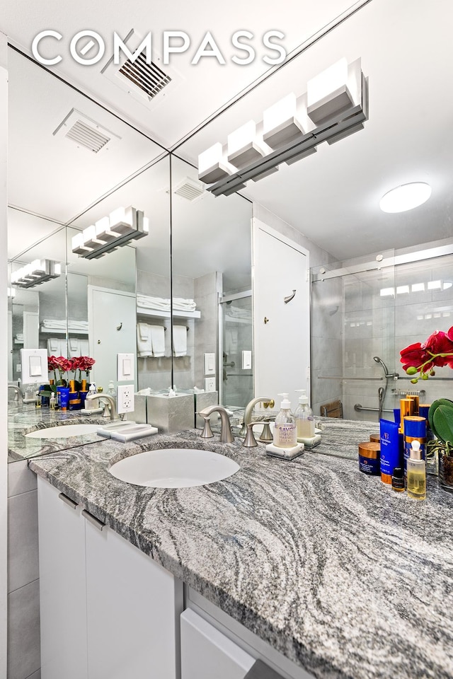 full bath with a shower stall and vanity