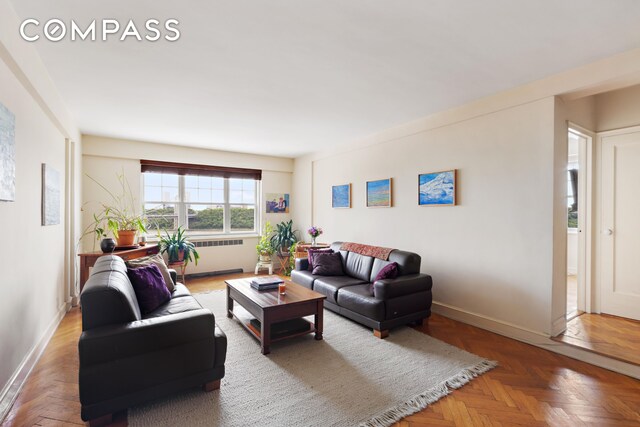 living area featuring baseboards