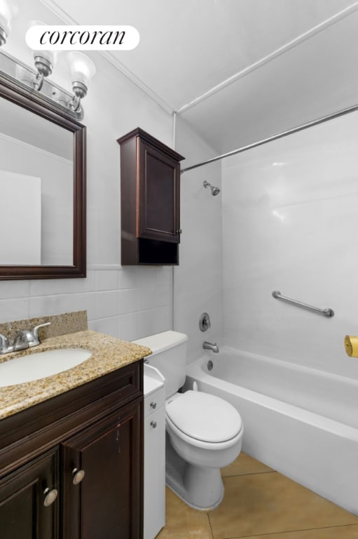 full bathroom with shower / bath combination, tile walls, vanity, decorative backsplash, and toilet