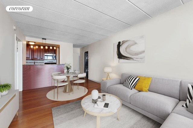 living room with hardwood / wood-style flooring and a textured ceiling