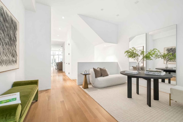 sitting room with baseboards, light wood-style flooring, and recessed lighting