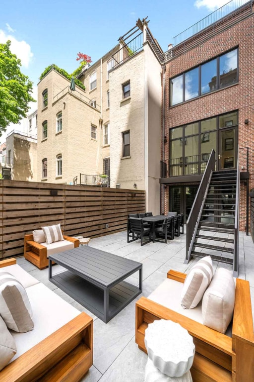 view of patio / terrace featuring outdoor dining space, stairway, and outdoor lounge area