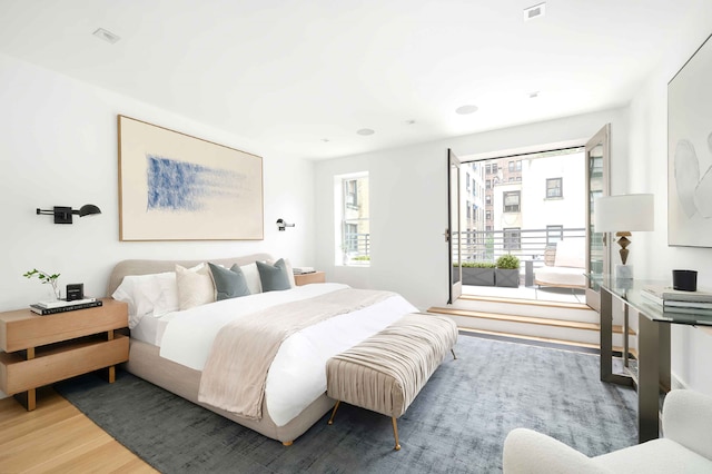 bedroom with visible vents and wood finished floors