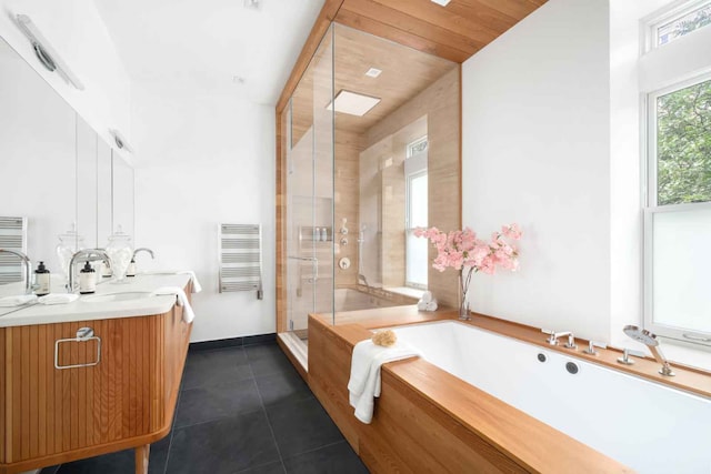 bathroom with double vanity, a stall shower, tile patterned flooring, and a bath