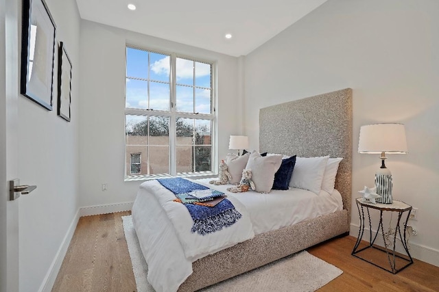 bedroom with hardwood / wood-style flooring