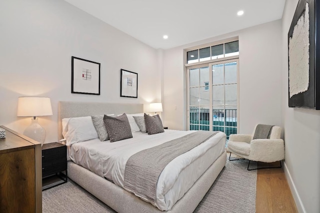 bedroom with light hardwood / wood-style flooring and access to outside