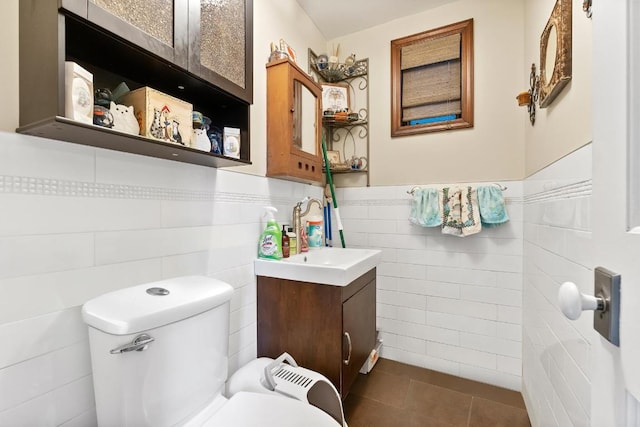 bathroom featuring toilet, vanity, and tile patterned flooring