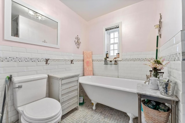 bathroom featuring toilet, a bathing tub, and tile walls