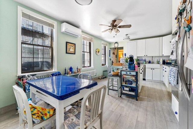 kitchen with decorative backsplash, white cabinetry, a center island, and a wall mounted air conditioner