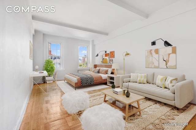 bedroom with beamed ceiling, baseboards, and wood finished floors