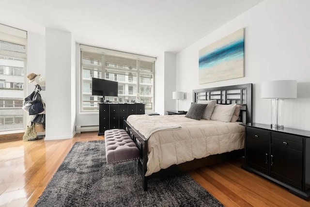 bedroom featuring light hardwood / wood-style flooring and a baseboard radiator