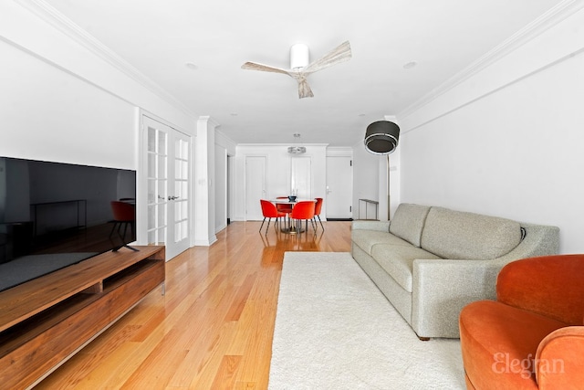 living room with french doors, ceiling fan, ornamental molding, and light hardwood / wood-style flooring