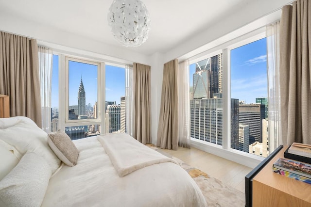 bedroom featuring a chandelier and light hardwood / wood-style flooring