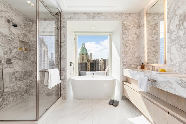 bathroom featuring vanity and shower with separate bathtub