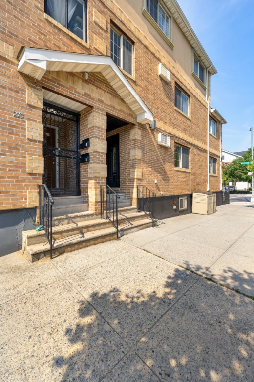 view of building exterior featuring an AC wall unit