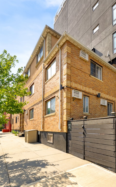 view of building exterior with a wall mounted air conditioner