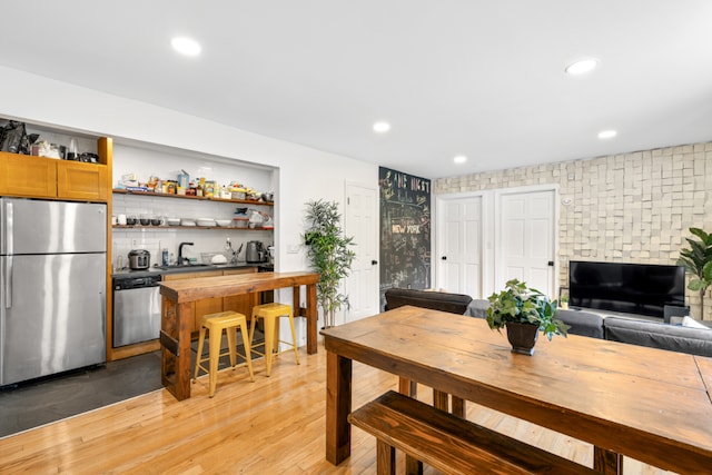 dining room featuring light wood-type flooring and sink