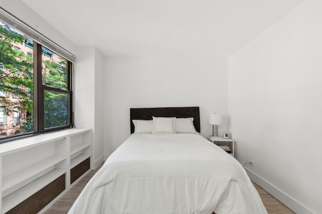 bedroom with hardwood / wood-style floors