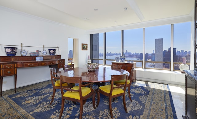 dining area with a city view and ornamental molding